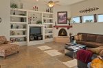 The open-plan living area with a Kiva fireplace and flat screen TV